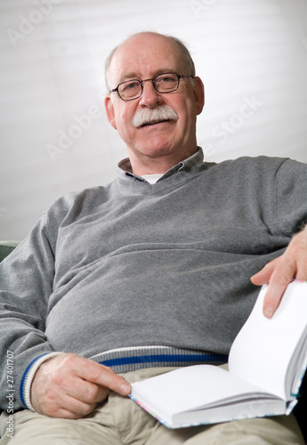Senior man is reading a book
