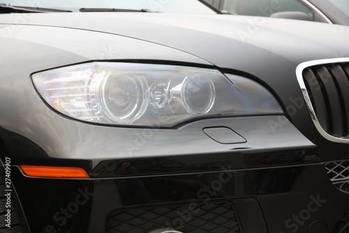 Closeup of car headlight © Arrows