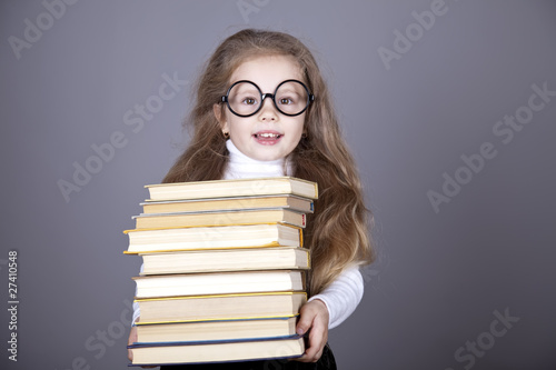 Little schoolgirl witn books.