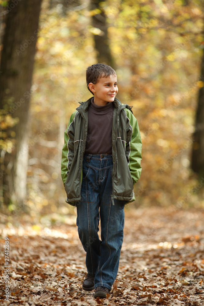 Boy walking through forest Boy walking through forest