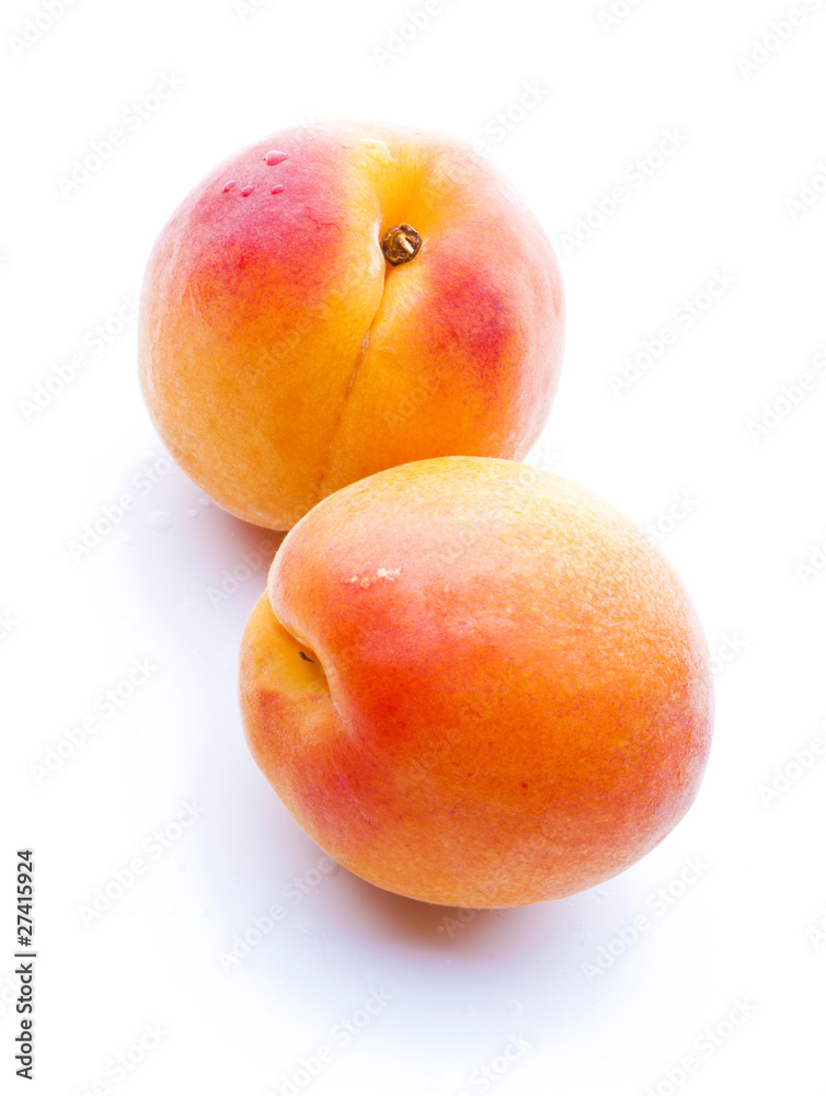 two apricots with water drops close-up two apricots with water drops close-up