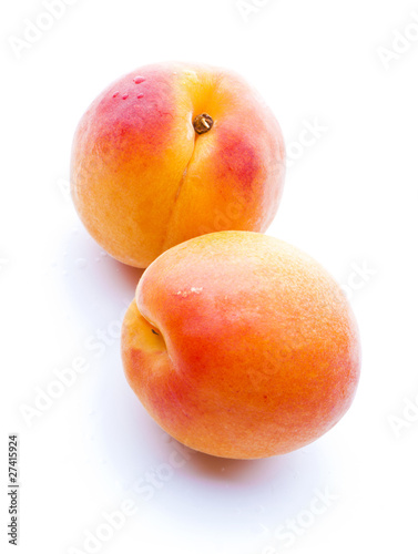 two apricots with water drops close-up