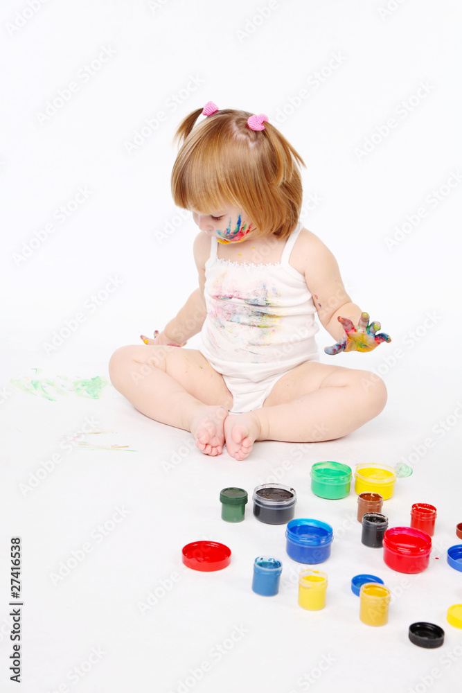 little girl bedaubed with bright colors little girl bedaubed with bright colors