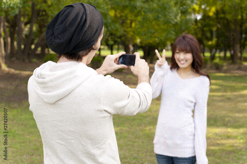 a portrait of young couple taking a photo a portrait of young couple taking a photo