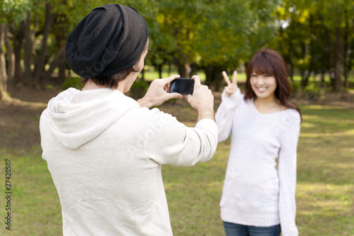 a portrait of young couple taking a photo