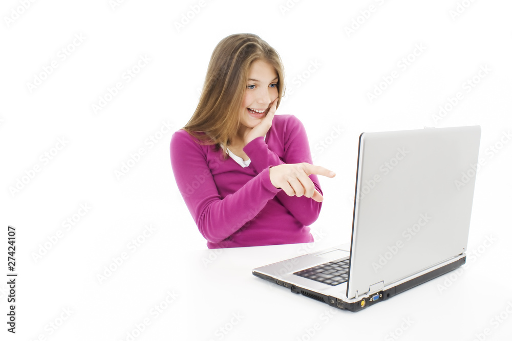 Surprised girl with laptop. Pointing at it. Over white Surprised girl with laptop. Pointing at it. Over white