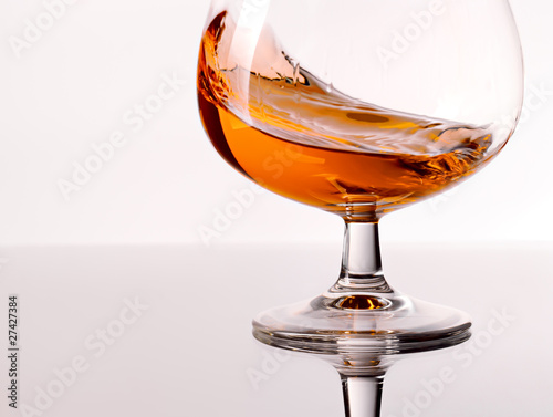 Cognac splashes in a glass