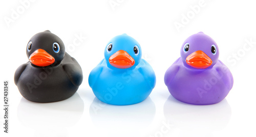 Three colorful rubber ducks over white background photo