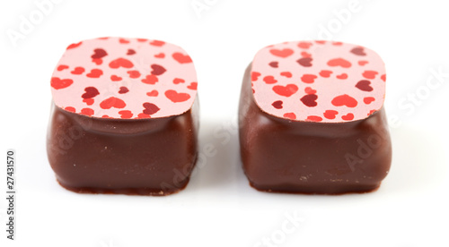 two chocolate candy bonbons over white background