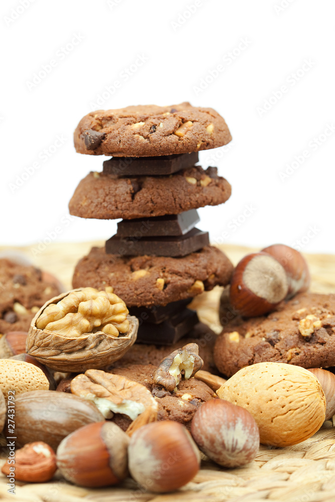 oatmeal cookies, chocolate and nuts on a wicker mat oatmeal cookies, chocolate and nuts on a wicker mat