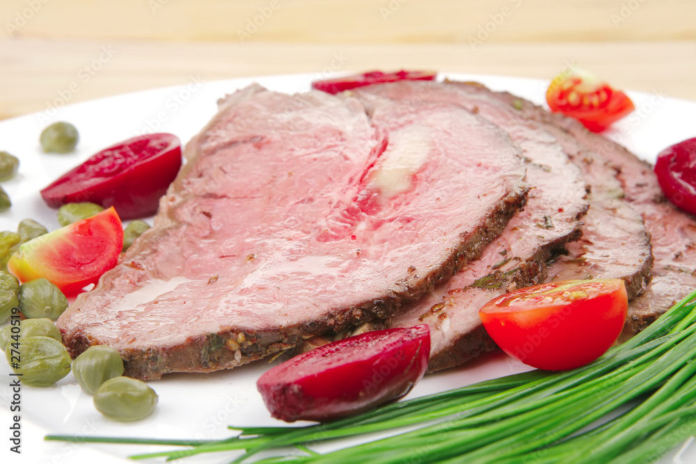 hot ham on white dish over wood