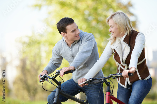 Attractive couple on bicycles