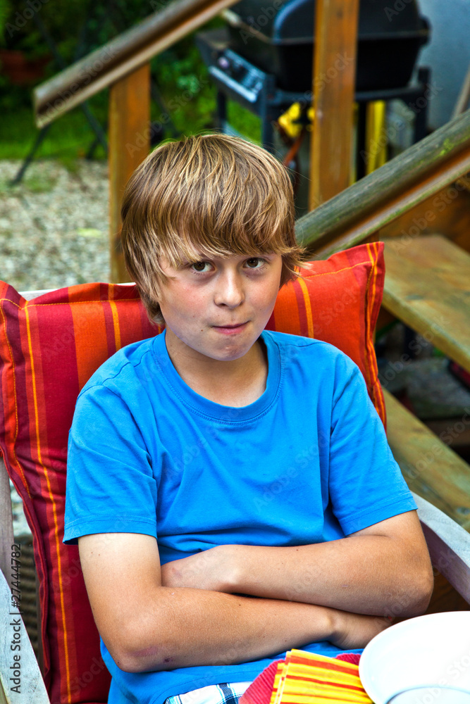 boy eating outside at a table boy eating outside at a table