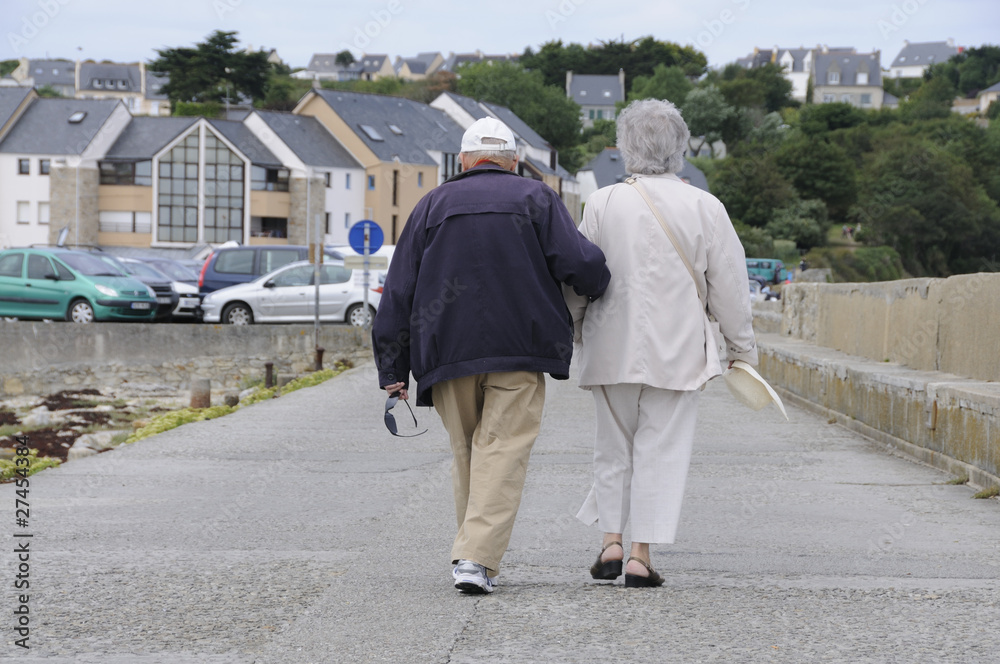 Old senior couple walking together holding their hands Old senior couple walking together holding their hands