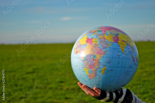 Globe on a child's hand © Nadiyka