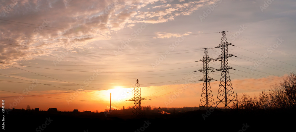 Electricity pylons and lines at dusk.