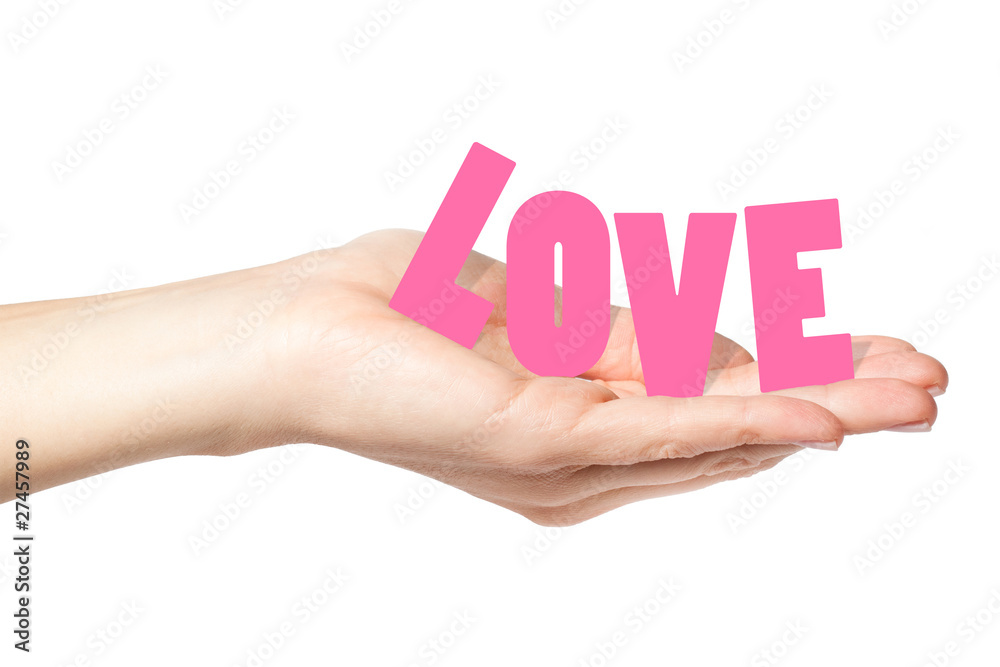 Beautiful female hand holding the word love Beautiful female hand holding the word love