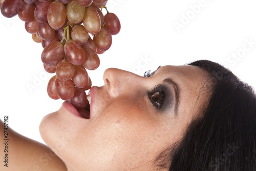 Closeup of woman eating grapes. photo