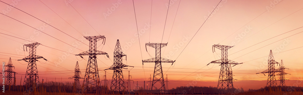 Electricity pylons and lines at dusk.