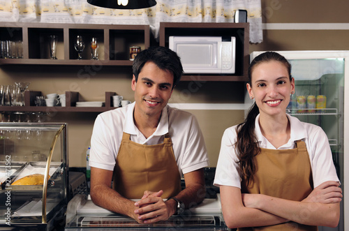 Waitress and waiter working at a cafe