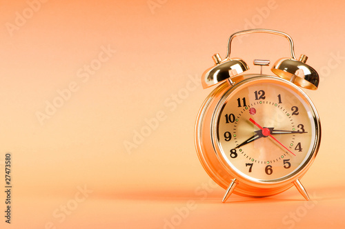 Time concept - alarm clock against colorful background