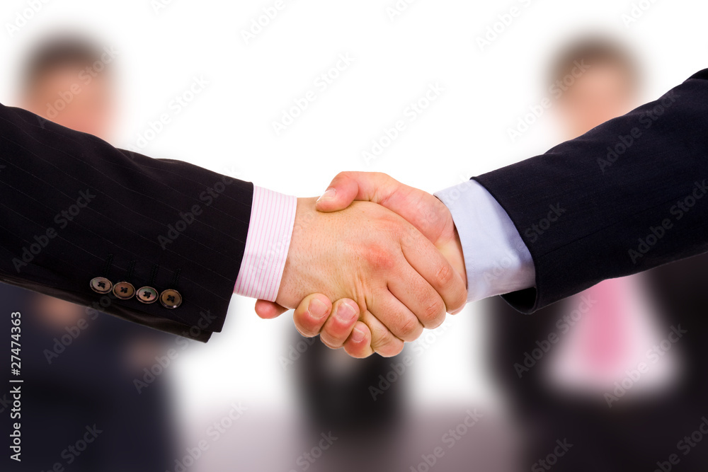 Closeup of business people shaking hands at the office Closeup of business people shaking hands at the office
