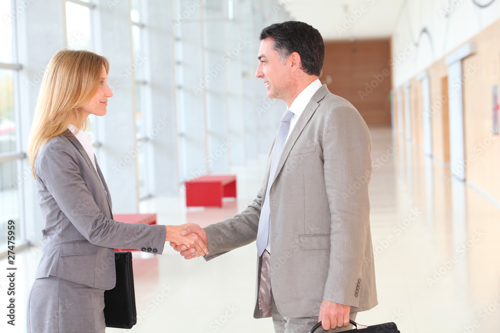 Business partners meeting in modern building Business partners meeting in modern building