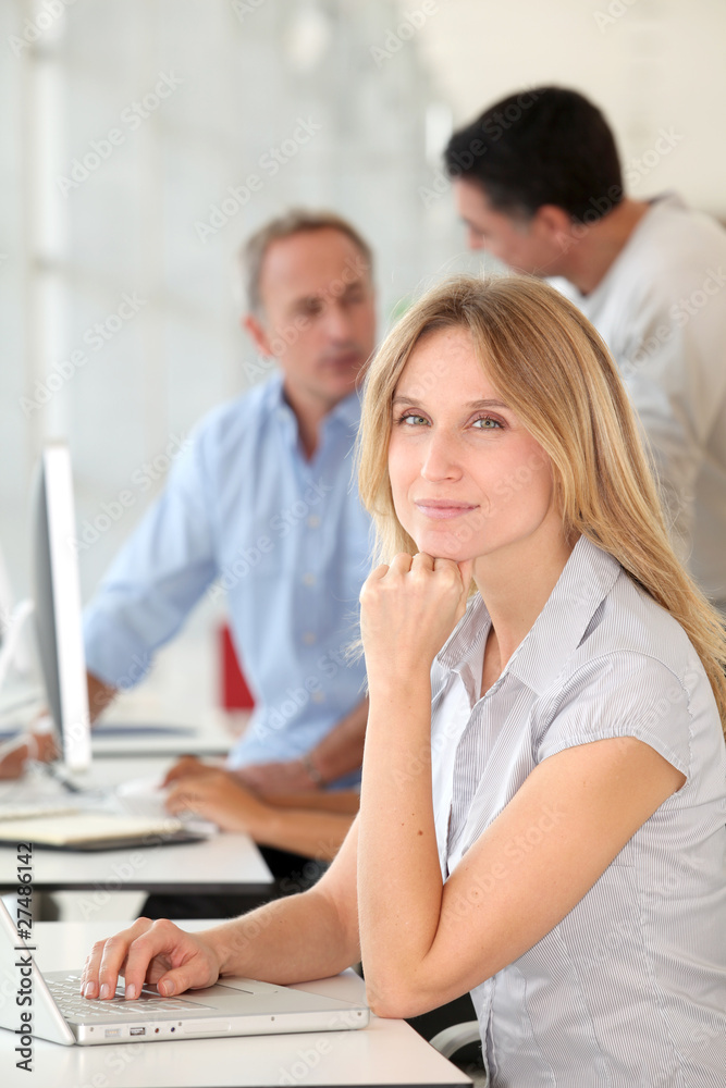 Beautiful woman working in the office on laptop computer Beautiful woman working in the office on laptop computer