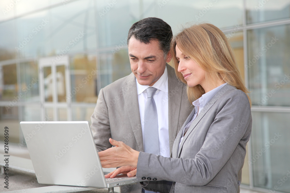 Sales people working outside modern building Sales people working outside modern building