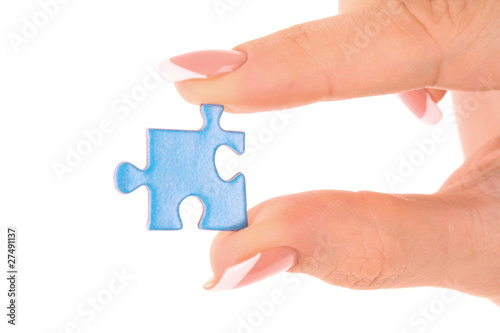 Hand with puzzle isolated on white