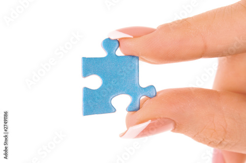 Hand with puzzle isolated on white