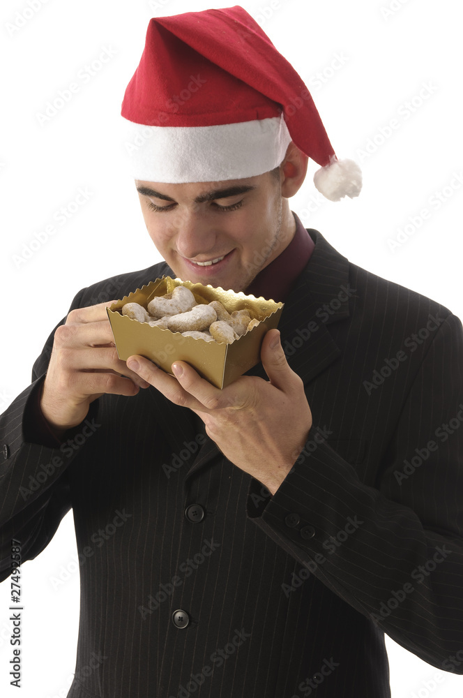 Junger Weihnachtsmann nascht Weihnachtsplätzchen Junger Weihnachtsmann nascht Weihnachtsplätzchen