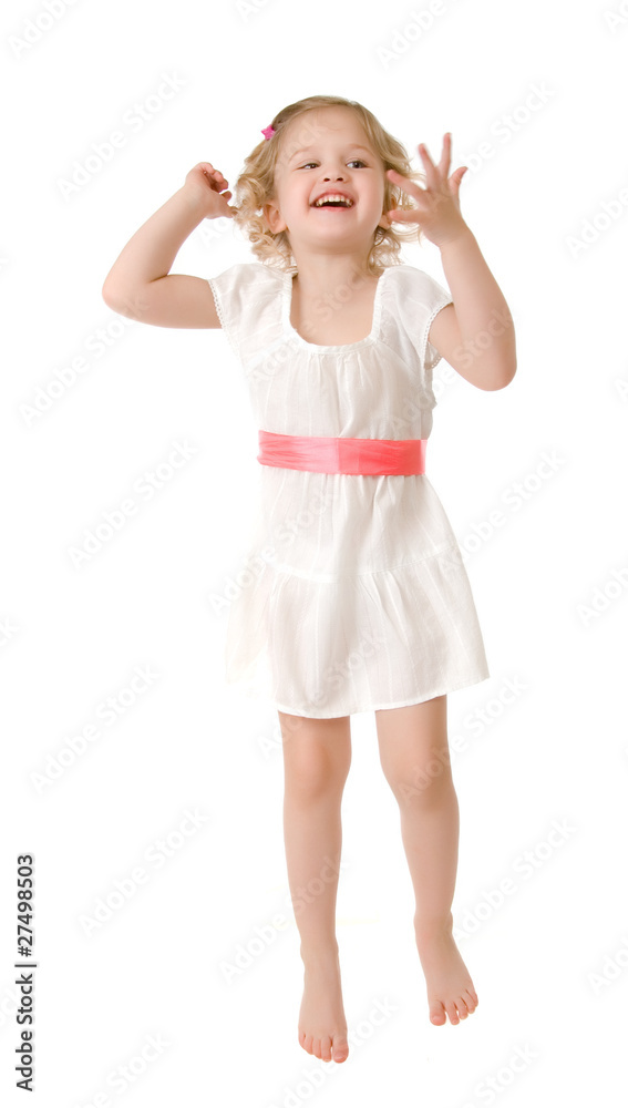 Little girl wearing a white dress jumping on white Little girl wearing a white dress jumping on white