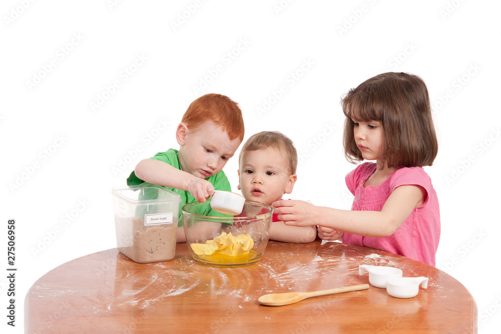 Kids measuring ingredients for baking in kitchen Kids measuring ingredients for baking in kitchen