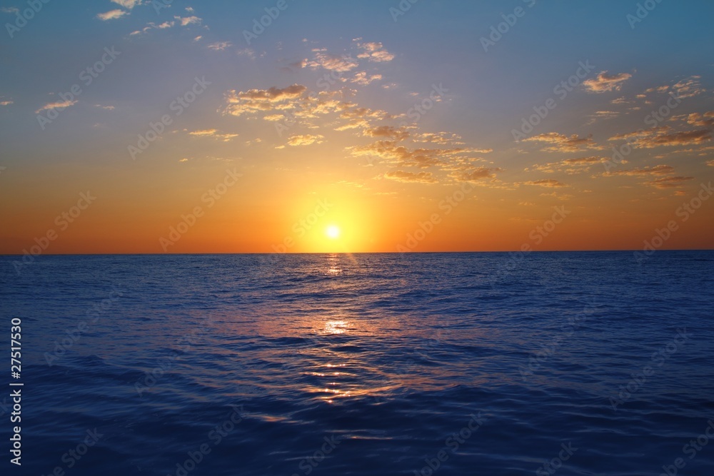 Sunrise sunset in ocean blue sea glowing sun