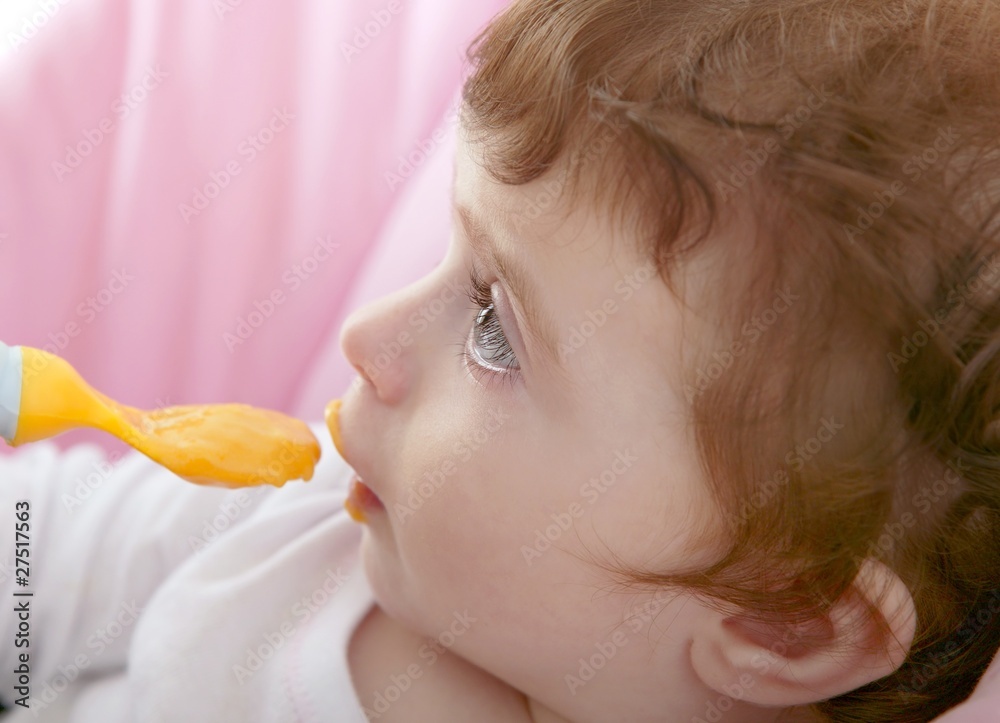 mother feeding baby yellow spoon mother feeding baby yellow spoon