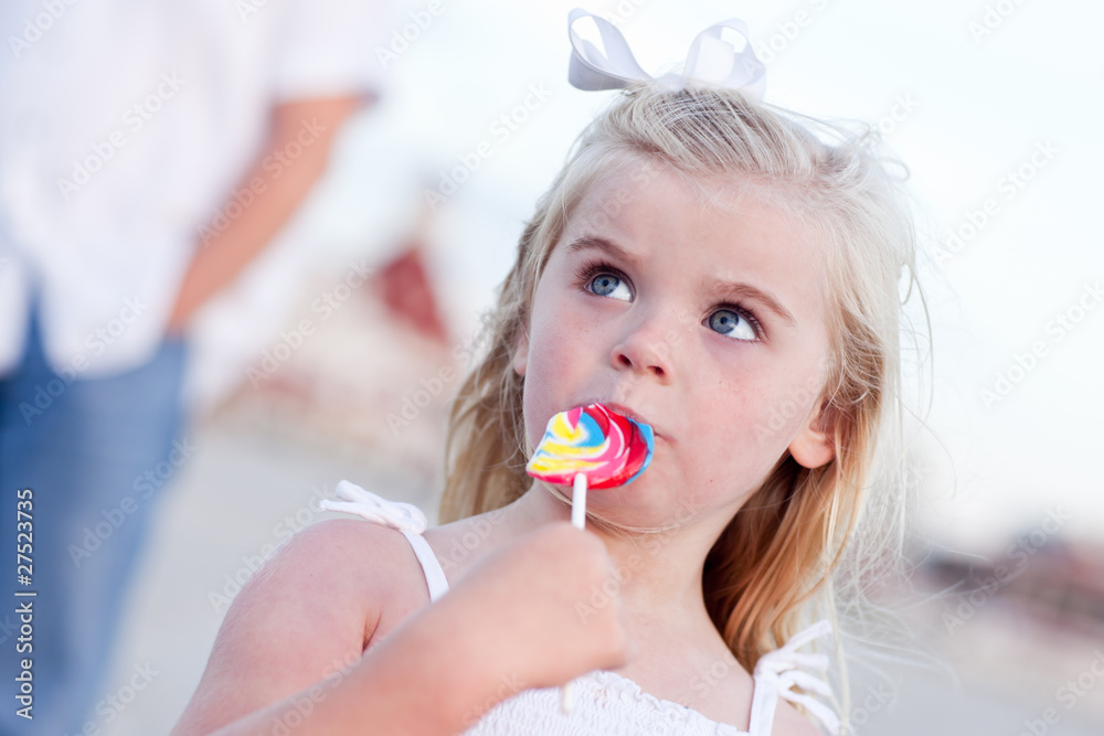 Adorable Little Girl Enjoying Her Lollipop Outside Adorable Little Girl Enjoying Her Lollipop Outside