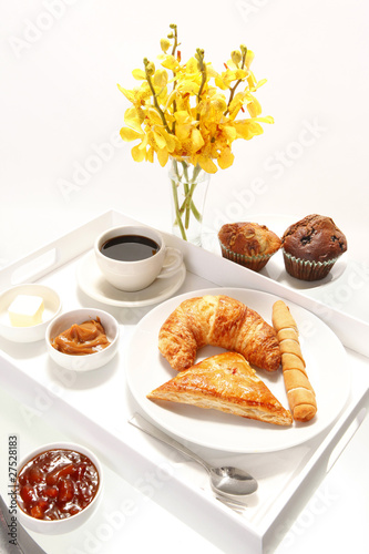 Assorted breakast pastries and orchid flowers photo