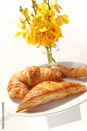 Assorted breakast pastries and orchid flowers photo