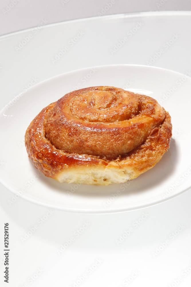 Cinnamon roll on white plate