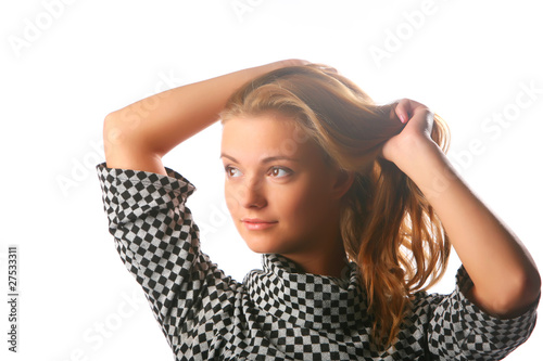 Blonde girl in a checkered dress on a white background