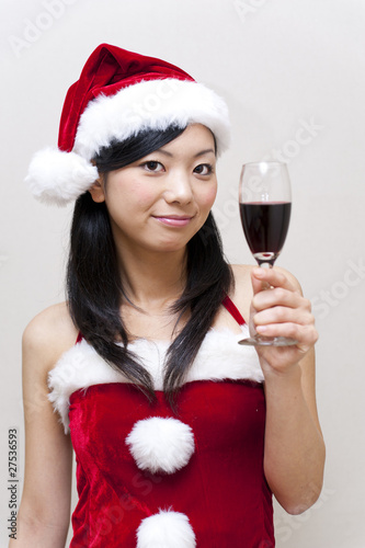 a portrait of santa girl taking a red wine