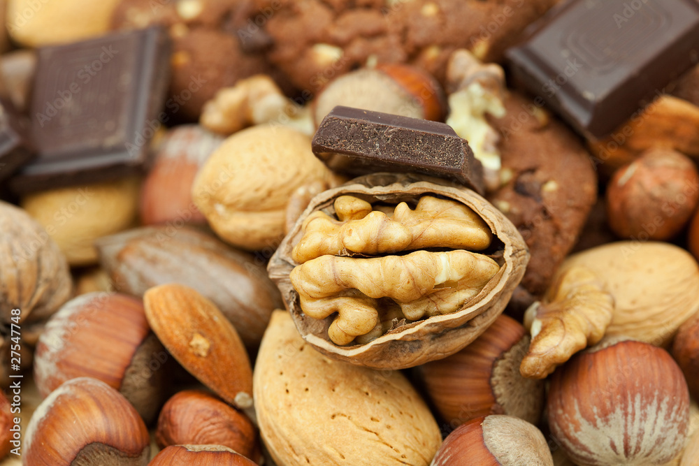 oatmeal cookies, chocolate and nuts on a wicker mat oatmeal cookies, chocolate and nuts on a wicker mat