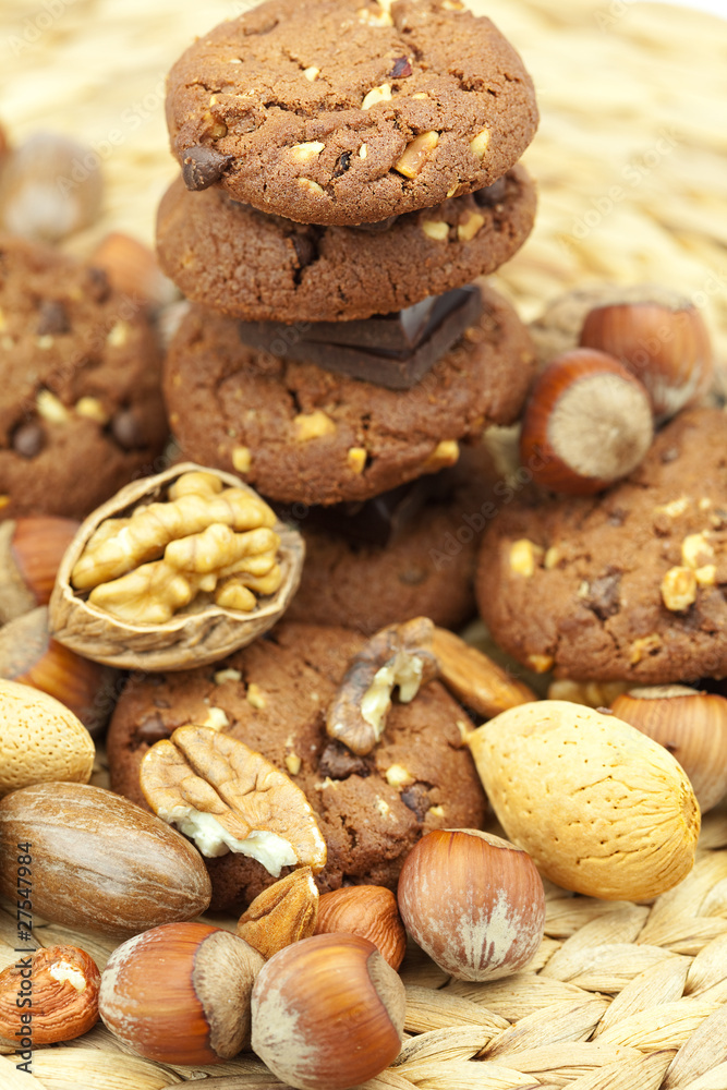 oatmeal cookies, chocolate and nuts on a wicker mat oatmeal cookies, chocolate and nuts on a wicker mat