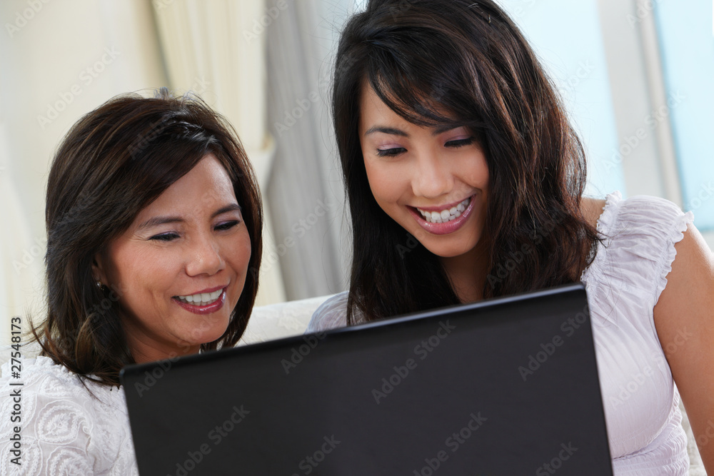 Mother and daughter using laptop Mother and daughter using laptop