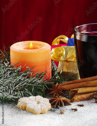 Candle and mulled wine with cookies  spices  gifts