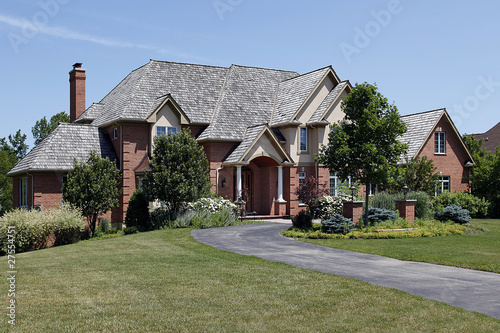 Large brick home with cedar roof