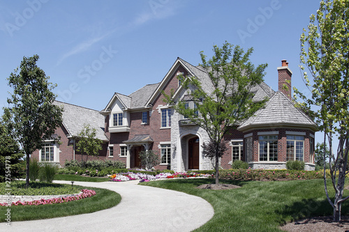 Large brick home with stone entry