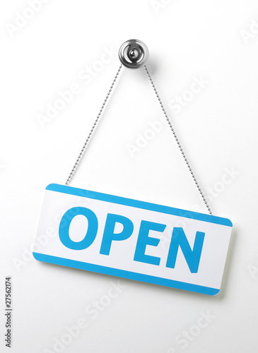 process blue angled open door sign on a silver chain on a white