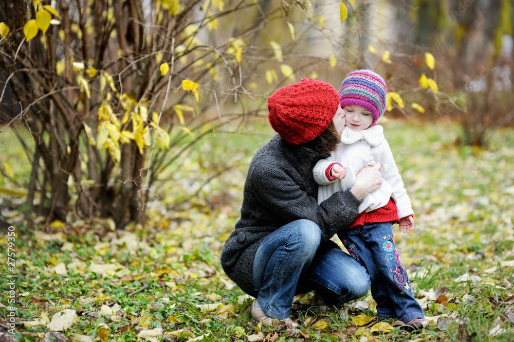 Young mother and her toddler girl in autumn Young mother and her toddler girl in autumn